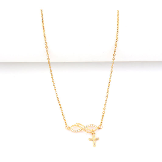 A delicate gold chain necklace featuring an infinity symbol and a small cross pendant, both adorned with tiny clear stones, displayed against a clean white background.