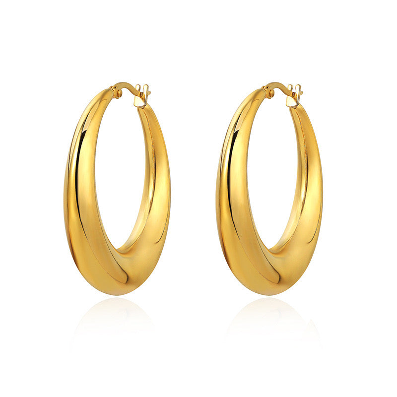 Gold hoop earrings on a white background