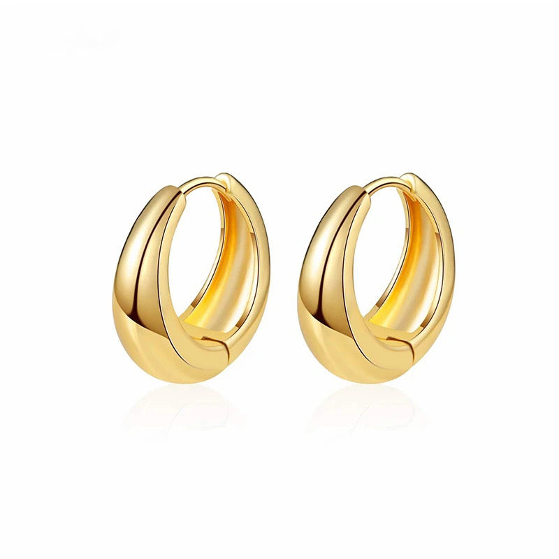 Gold hoop earrings on a white background