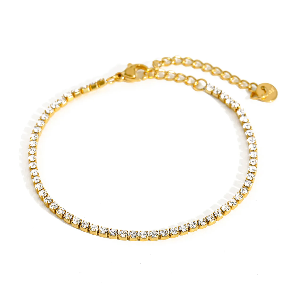 Gold anklet with clear crystals on a white background
